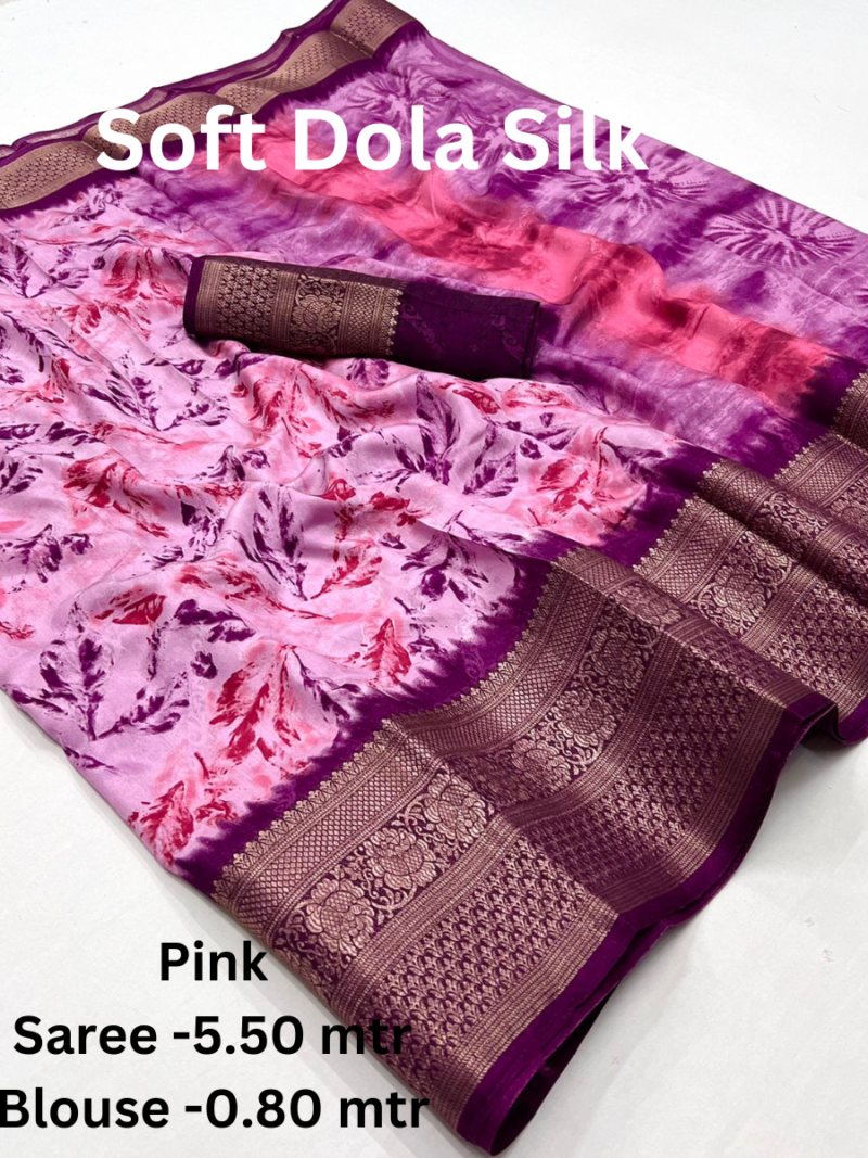 A red Soft Dola Silk Saree with a large, intricately woven border and a double shaded effect. The saree comes with a matching blouse piece.