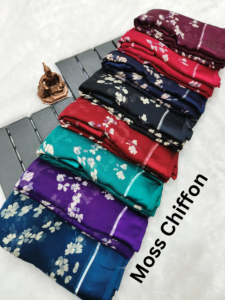 A collection of folded sarees featuring beautiful floral prints in a variety of colors.